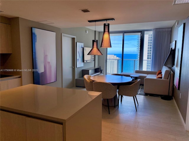 dining space featuring visible vents and light wood-style flooring