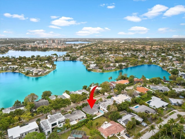 birds eye view of property with a water view and a residential view