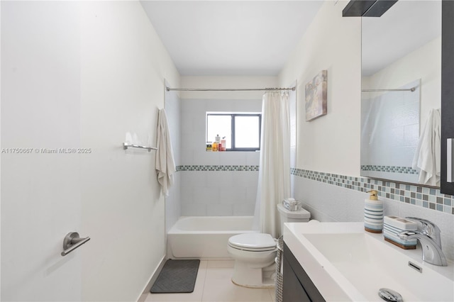 full bath featuring tile walls, toilet, shower / bath combo with shower curtain, vanity, and tile patterned floors