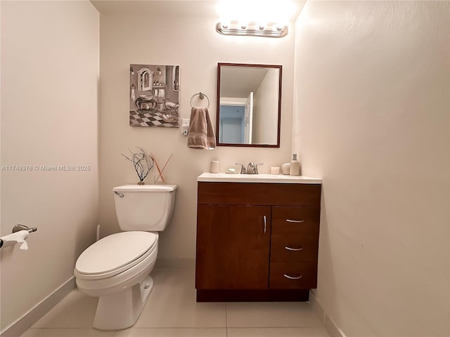 half bathroom with tile patterned flooring, vanity, toilet, and baseboards