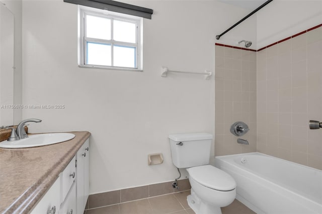 bathroom featuring baseboards, toilet, tile patterned floors, vanity, and washtub / shower combination