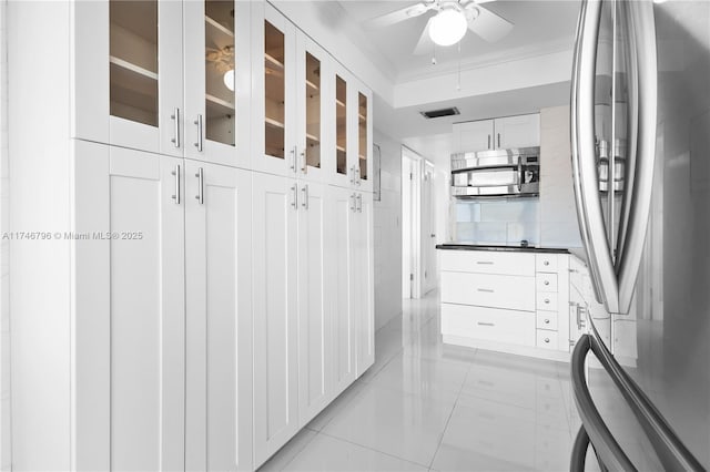 hallway featuring visible vents, light tile patterned flooring, tile walls, and crown molding