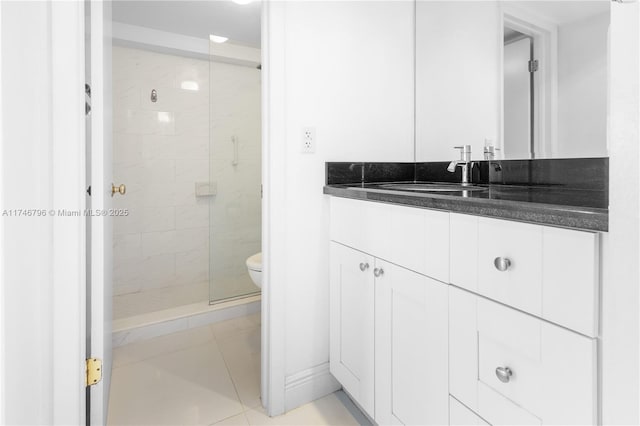 bathroom featuring a stall shower, vanity, and toilet