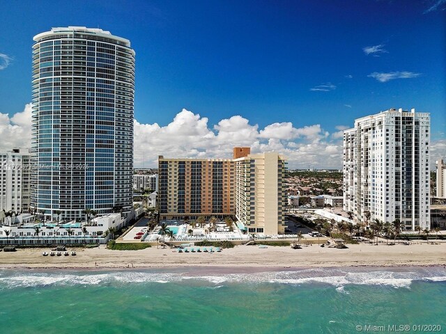 exterior space with a water view and a view of the beach