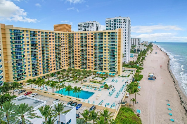 view of building exterior with a city view, a water view, and a beach view