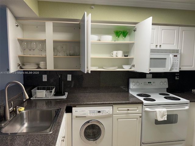 kitchen featuring dark countertops, washer / dryer, white cabinetry, and white appliances