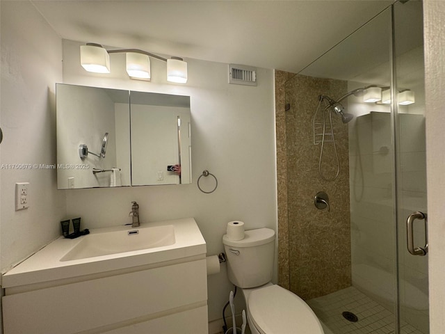 full bath featuring toilet, a stall shower, vanity, and visible vents