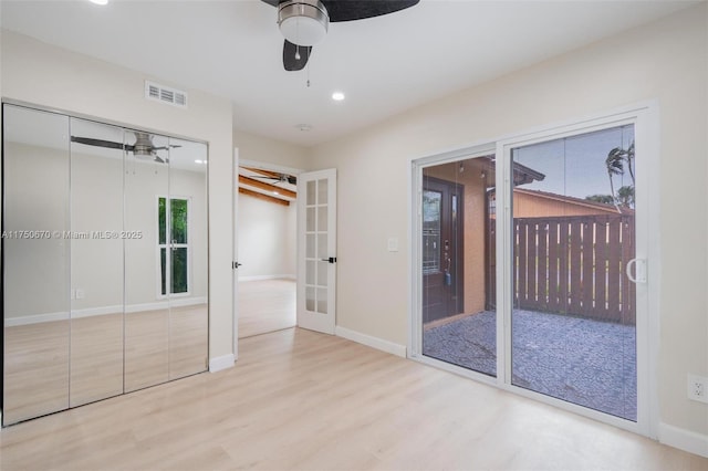 17329 Birchwood Ln Unit A, Fort Myers, FL 33908 - unfurnished bedroom with french doors, baseboards, access to outside, visible vents, and wood finished floors