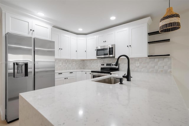 17329 Birchwood Ln Unit A, Fort Myers, FL 33908 - kitchen with a sink, tasteful backsplash, appliances with stainless steel finishes, and light stone countertops