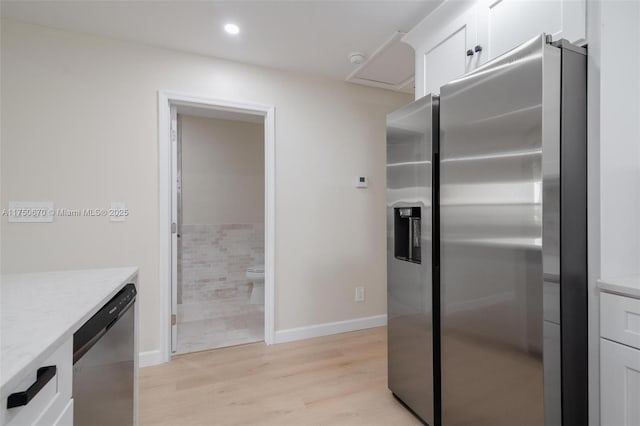 17329 Birchwood Ln Unit A, Fort Myers, FL 33908 - kitchen featuring light wood finished floors, white cabinetry, light stone countertops, appliances with stainless steel finishes, and recessed lighting