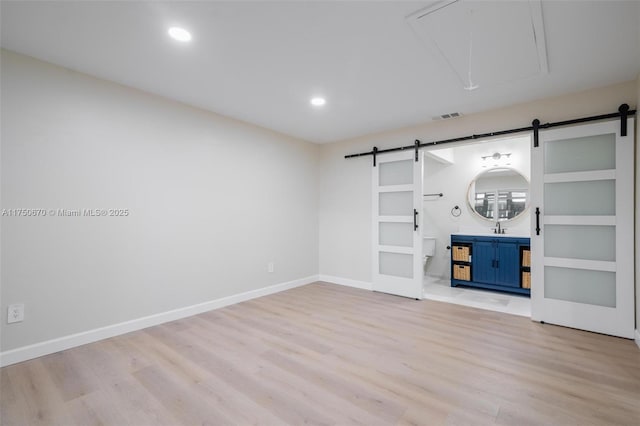 17329 Birchwood Ln Unit A, Fort Myers, FL 33908 - unfurnished room with attic access, visible vents, a barn door, and a sink