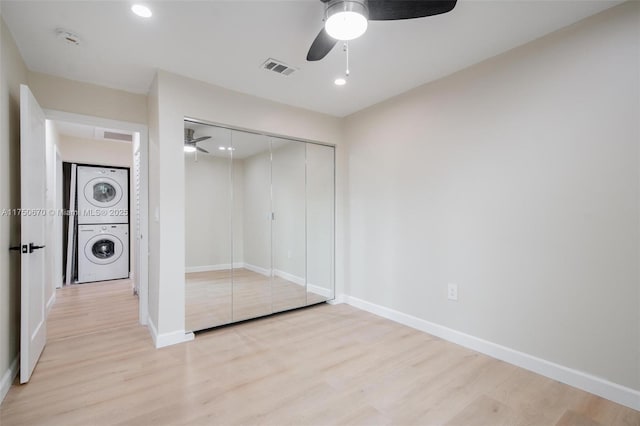 17329 Birchwood Ln Unit A, Fort Myers, FL 33908 - unfurnished bedroom with a closet, light wood finished floors, stacked washer and clothes dryer, baseboards, and visible vents