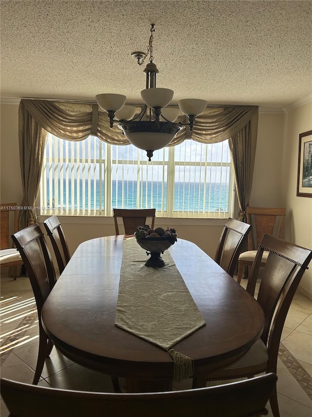 tiled dining area featuring crown molding and a textured ceiling