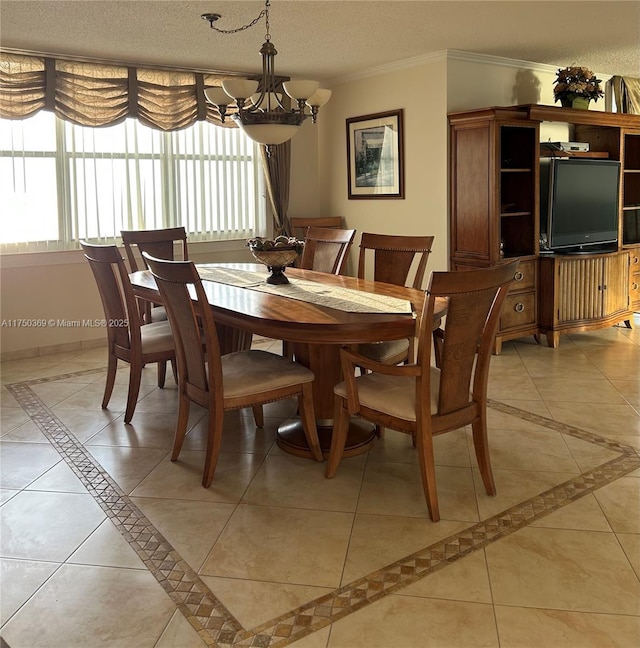 dining room featuring light tile patterned floors, a textured ceiling, baseboards, and crown molding