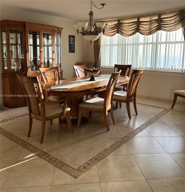 dining room with light tile patterned floors, baseboards, a chandelier, and crown molding