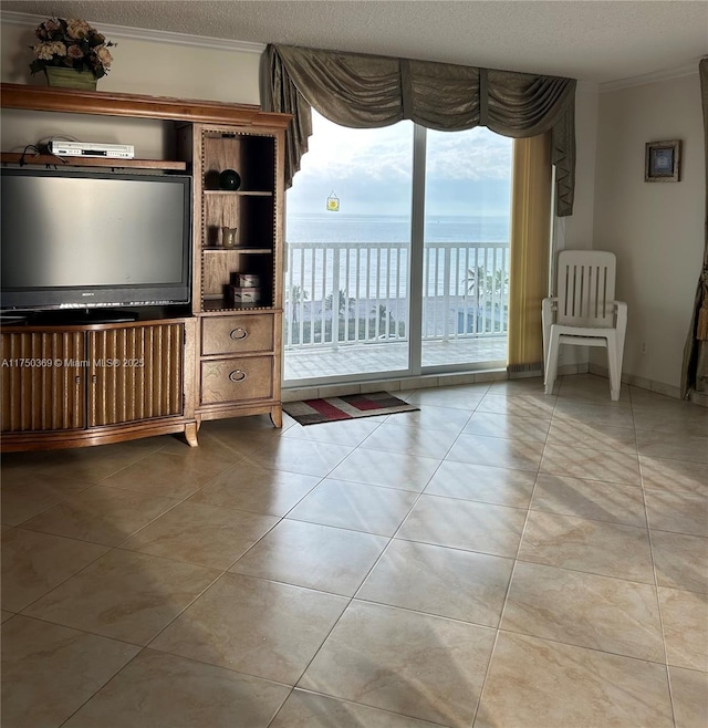 unfurnished living room featuring a textured ceiling, tile patterned flooring, and crown molding