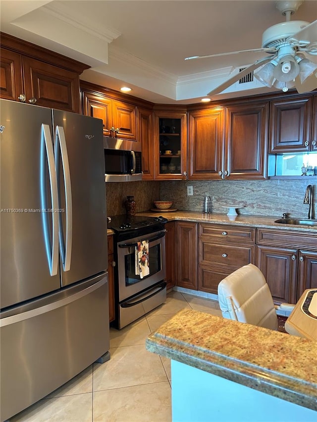 kitchen featuring stainless steel appliances, backsplash, ornamental molding, light tile patterned flooring, and a sink