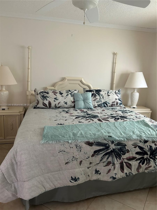 bedroom with light tile patterned floors, ornamental molding, and a textured ceiling