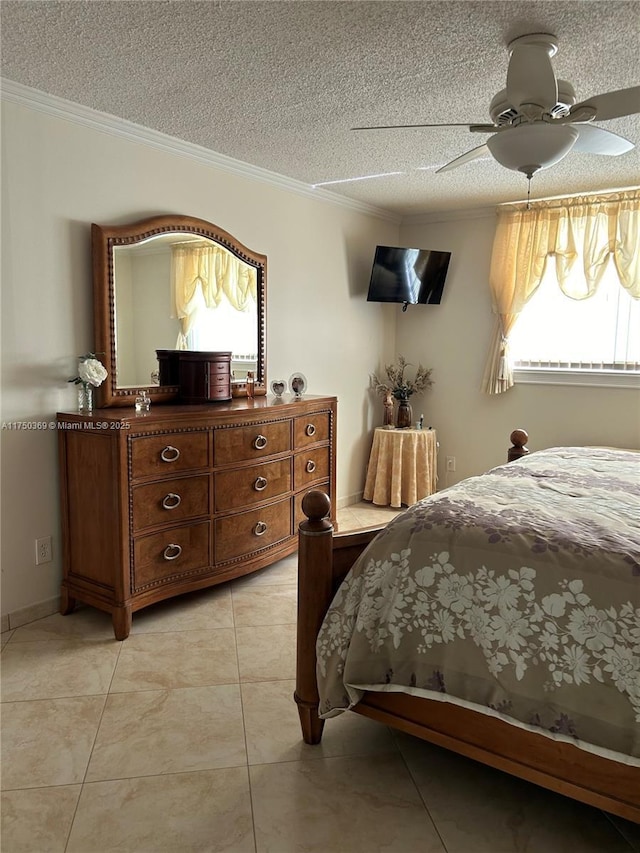 bedroom featuring light tile patterned floors, ceiling fan, ornamental molding, and a textured ceiling