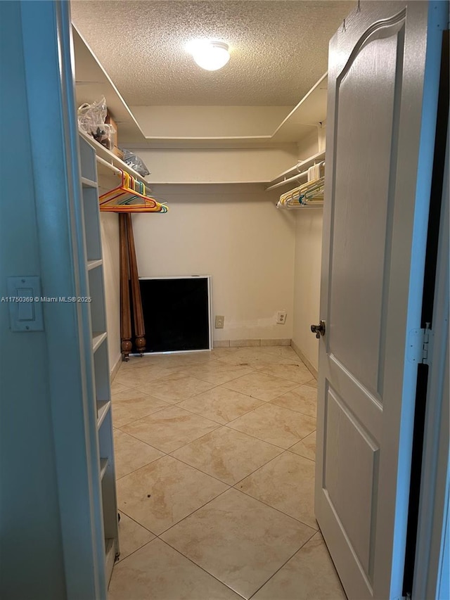 spacious closet featuring light tile patterned floors