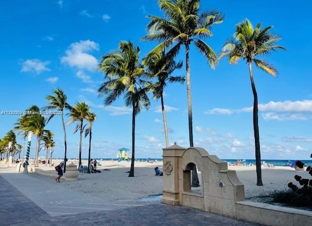 surrounding community featuring a water view and a view of the beach