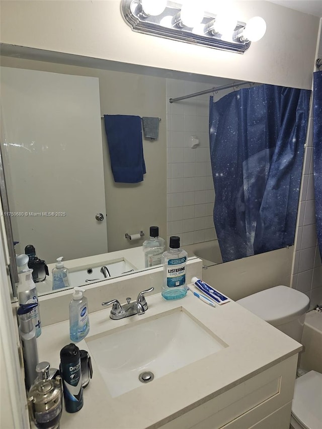 full bath featuring vanity, shower / bath combination with curtain, and toilet