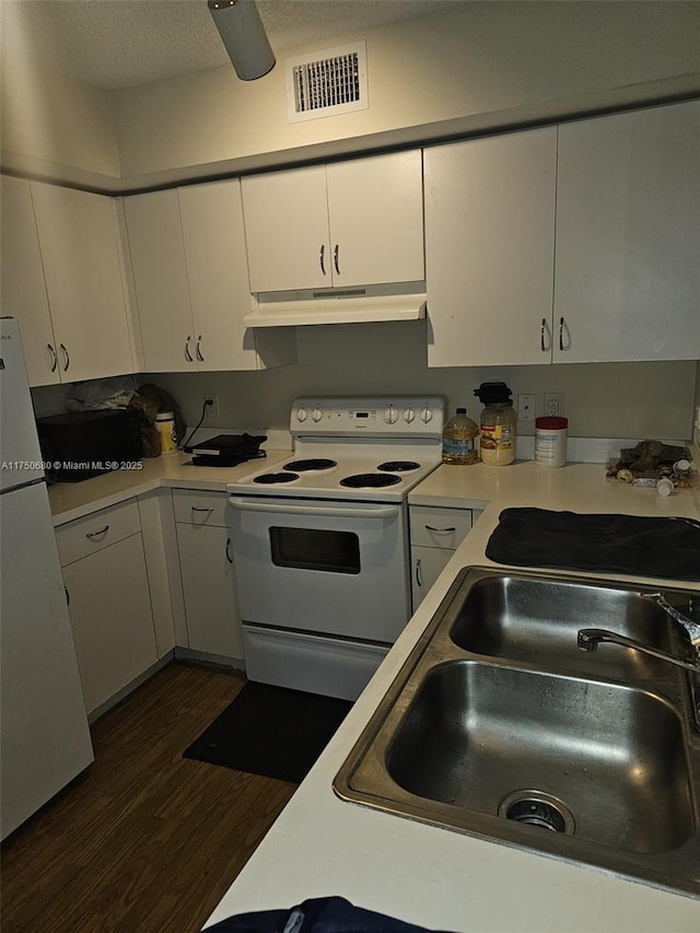 kitchen featuring light countertops, visible vents, white cabinetry, white appliances, and under cabinet range hood