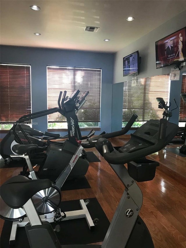 workout area with visible vents, wood finished floors, and recessed lighting