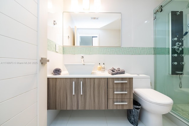 bathroom with toilet, a shower stall, tile walls, and vanity