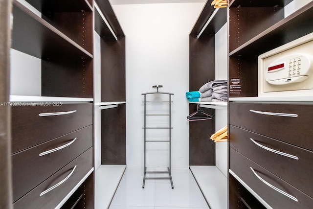 walk in closet with tile patterned floors