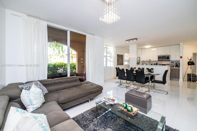 living room featuring a notable chandelier and light tile patterned floors