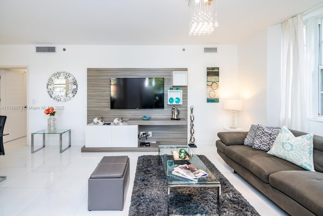 living area featuring visible vents and an inviting chandelier