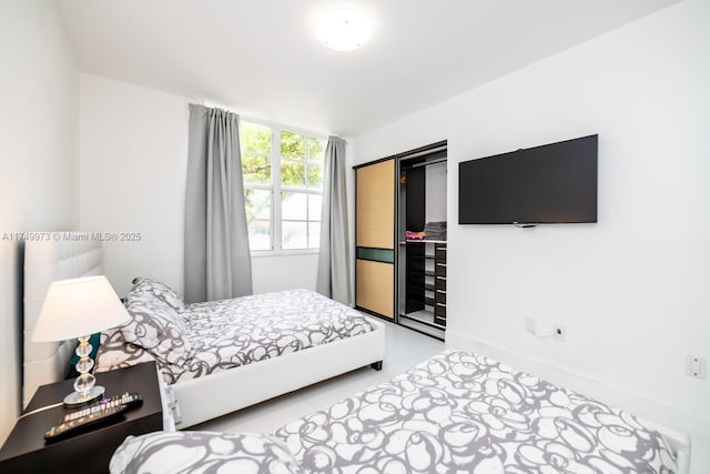 bedroom with a closet and baseboards