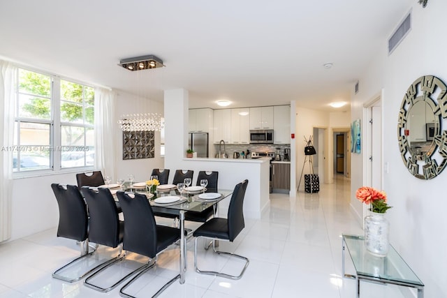 dining space featuring light tile patterned flooring and visible vents