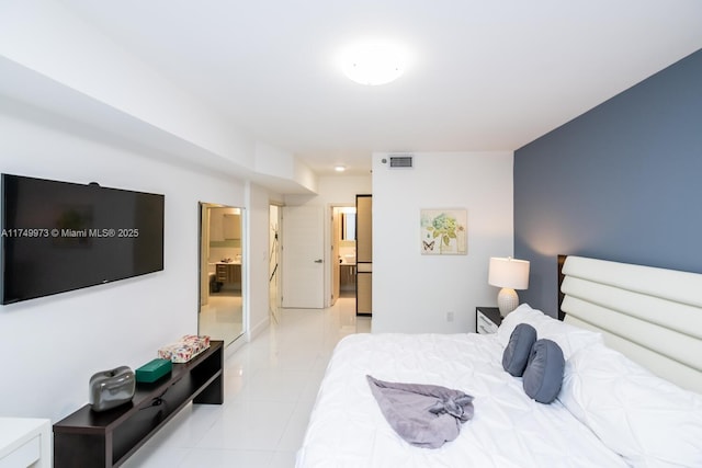 bedroom with light tile patterned floors and visible vents