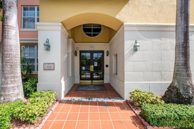 property entrance featuring french doors and stucco siding