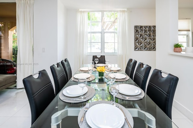 dining space featuring light tile patterned floors