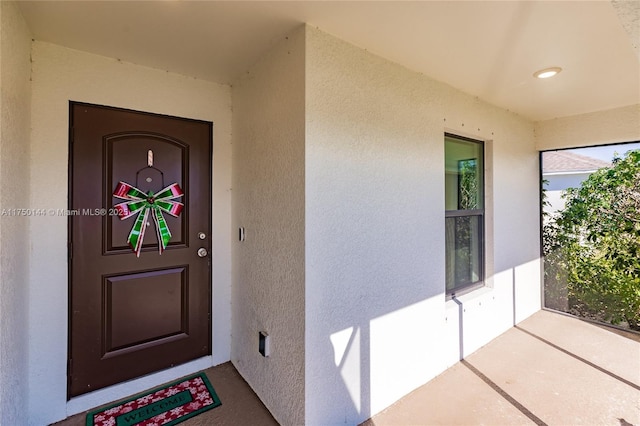 property entrance featuring stucco siding