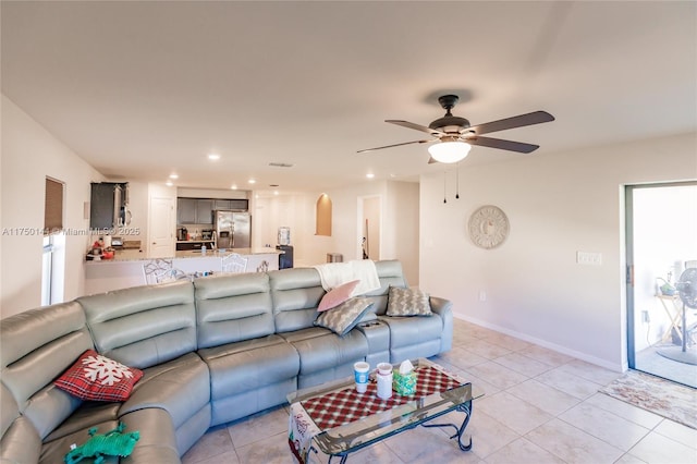 living room featuring light tile patterned floors, baseboards, a ceiling fan, and recessed lighting