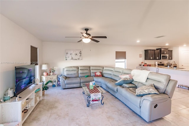 living room with a ceiling fan, recessed lighting, and light tile patterned floors