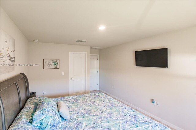 bedroom featuring visible vents and baseboards