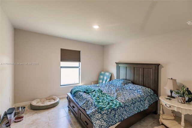 bedroom featuring light tile patterned floors and baseboards