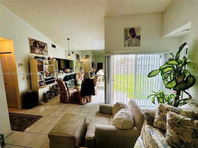 living area featuring lofted ceiling, a textured ceiling, and light tile patterned floors