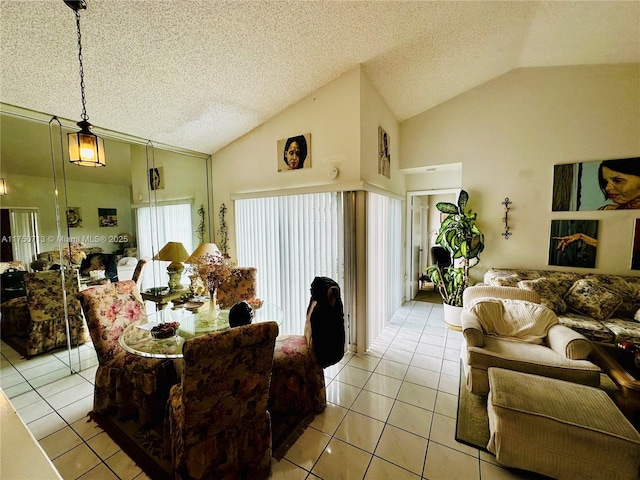 living area featuring vaulted ceiling, a textured ceiling, and light tile patterned flooring