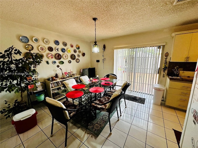 dining room featuring light tile patterned floors and a textured ceiling