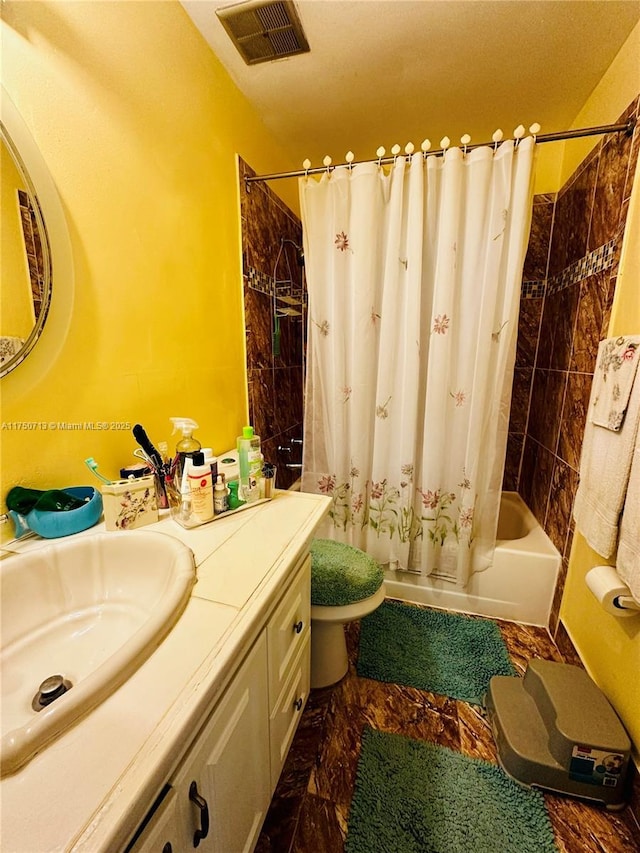 bathroom featuring toilet, vanity, visible vents, and shower / bathtub combination with curtain