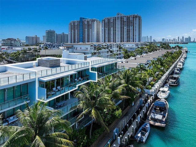 birds eye view of property featuring a water view and a view of city