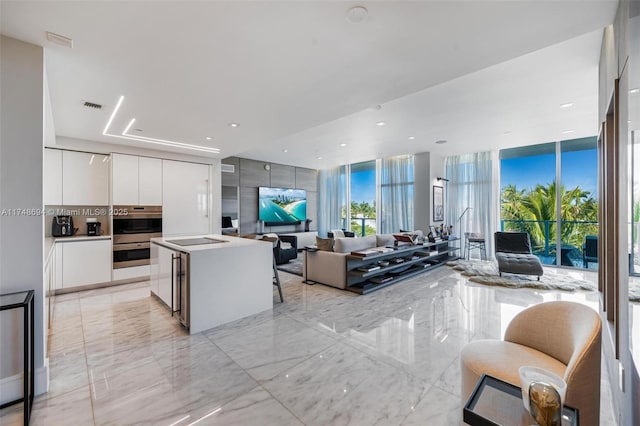 kitchen with marble finish floor, white cabinets, visible vents, and modern cabinets