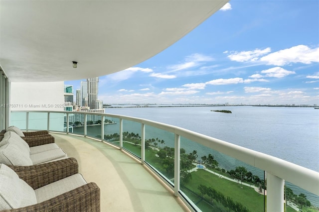 balcony featuring a view of city and a water view