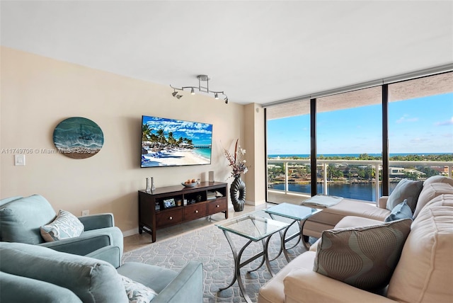 living room featuring expansive windows, baseboards, and track lighting